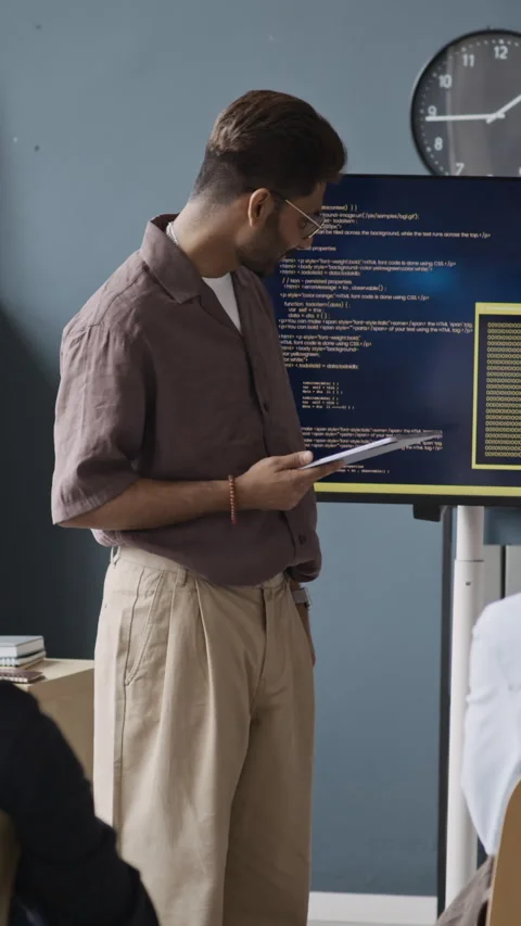 Vertical of Indian Businessman Explaining Programming Code during IT Meeting Stock Footage 337474073