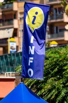 Vertical information flag next to blue tent outdoors Stock Photos