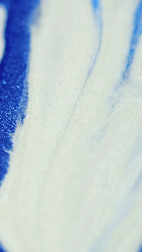 Vertical ink spill glitter paint mix blue white Stock Footage 285007125