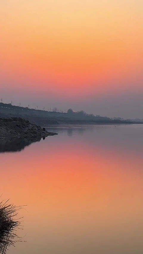 Vertical Intense Orange Sunset Glow and Silhouetted Landscape Stock-Footage 333488237