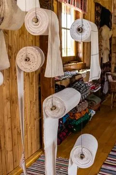 Vertical Interior View of Woven Linen Fabric Rolls Displayed in Museum Stock Photos