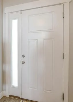Vertical Interior of a white front door of a house with side glass panel Stock Photos