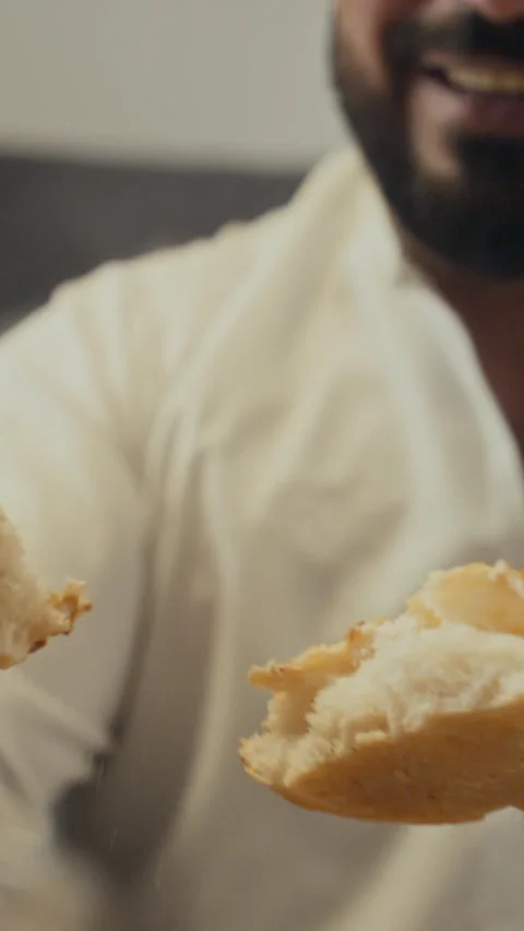 Vertical of Islamic Man Breaking Bread and Sharing on Sweet Eid Stock Footage 266413042
