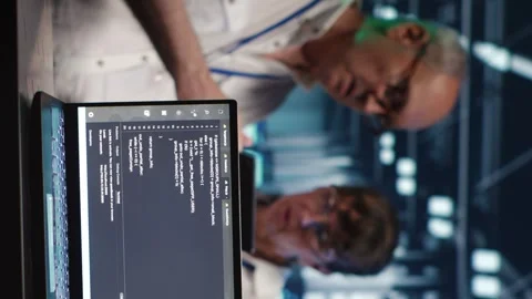 Vertical IT team running code in data center Stock Footage 248420351