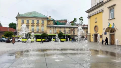 Vertical jets of the ornamental dry deck fountain on Mytnaya Square. Lviv. Stock Footage 319433377
