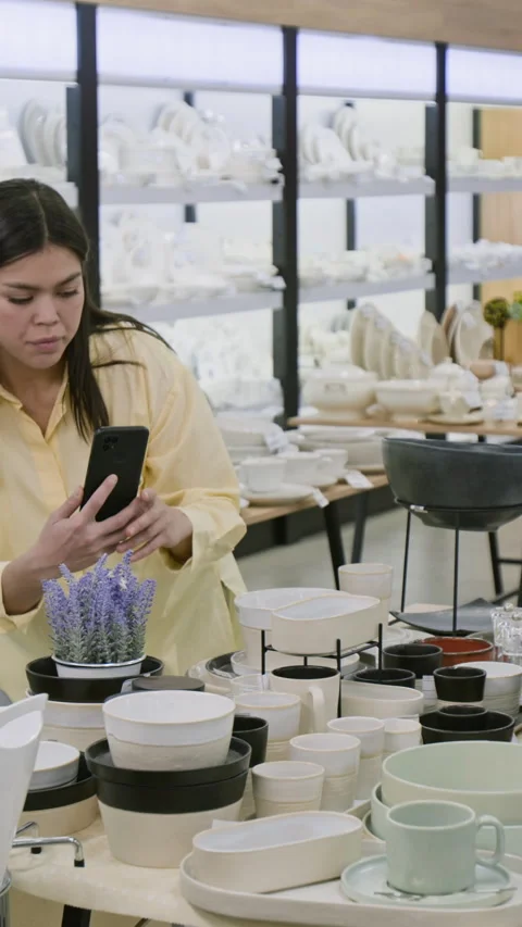 Vertical of Kitchenware Store Manager Taking Smartphone Photos of Displays Stock Footage 323054528
