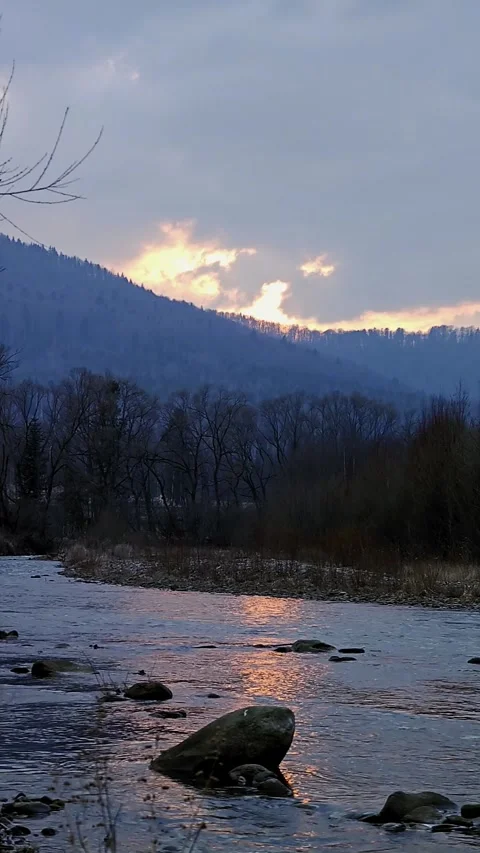 Vertical landscape of a mountain river during a beautiful winter sunset Stock Footage 333901805