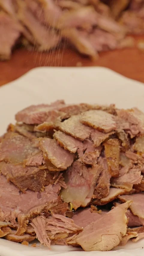 Vertical A large plate piled high with braised beef slices. Stock Footage 343327599