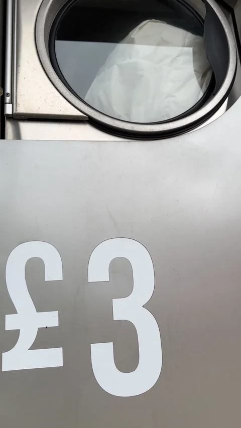 Vertical. Last step of drying laundry in the launderette dryer machine. Vídeos de archivo 275344444