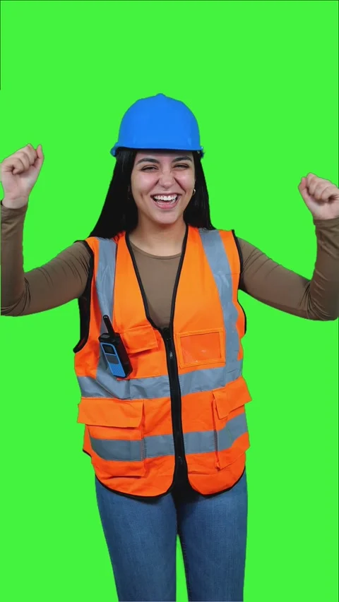 Vertical Latin construction worker celebrating success on green screen Stock Footage 308743389