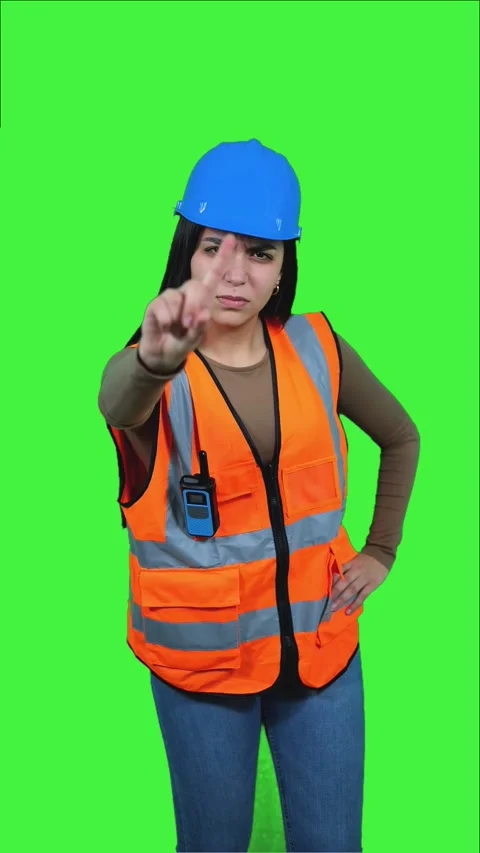Vertical Latin construction worker woman pointing with index finger on gree.. Stock Footage 308743386