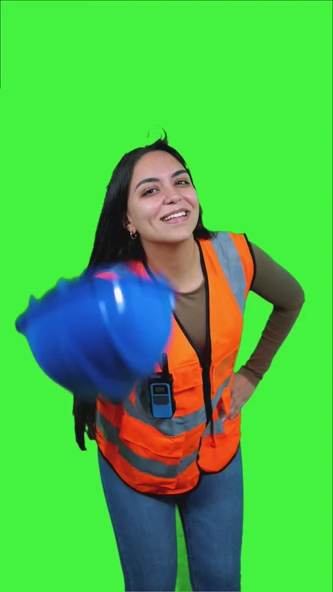 Vertical Latin Construction Worker Woman Playing With Her Helmet on Green S.. Stock Footage 308743387