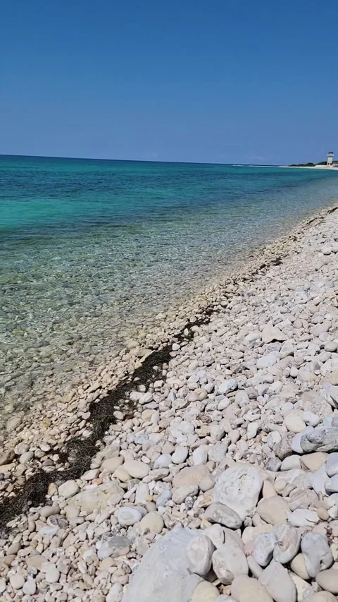 Vertical limestone beach with crystal clear water and radiant sun Video stock 329072541