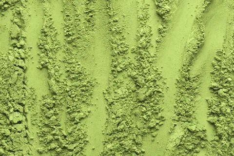 Vertical lines and clusters of matcha tea powder create a structured yet or.. Stock Photos