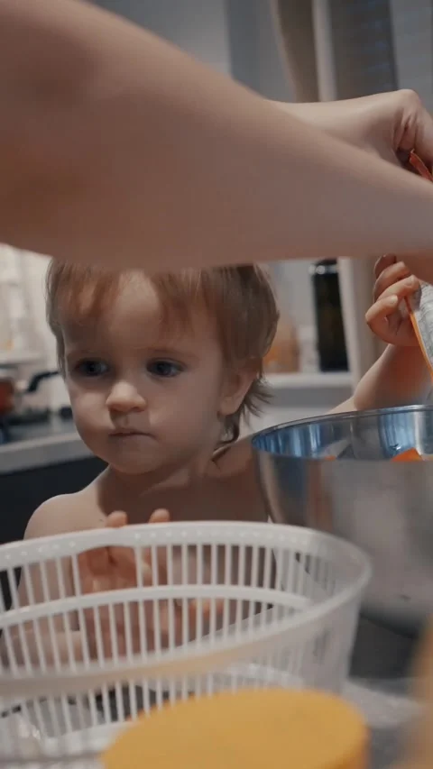 Vertical of Little Boy Sitting in Kitchen Next to Sink Stock Footage 274144596