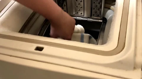 Vertical load washing machine open and take out the laundry Stock Footage 266056380