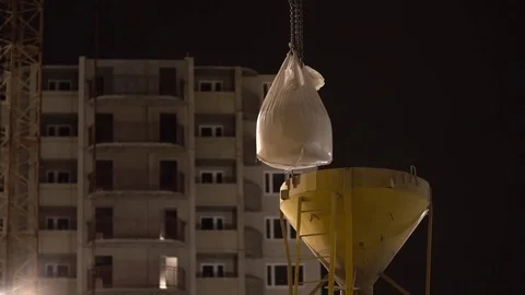 Vertical loading of the cement bag. Careless work. Dust flies through the air Stock Footage 75514611
