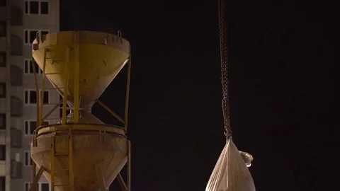 Vertical loading of the cement bag on the construction site at night. Stock Footage 75329220
