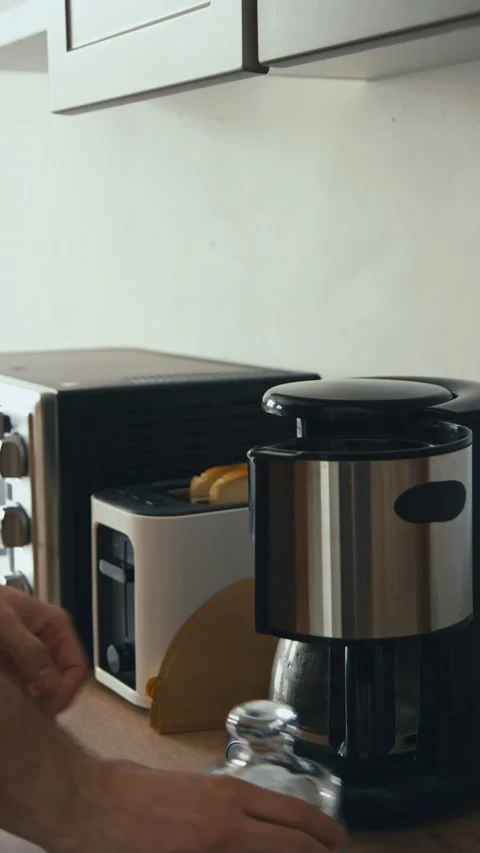 Vertical of Loading Coffee Machine and Turning It on Stock Footage 259289977