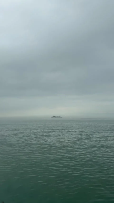 Vertical Lone Ship Sailing on Distant Sea Horizon 4K 库存影片 332036986