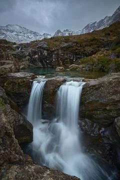 Vertical long double cascade with turquoise water between idyllic landscape o Stock Photos