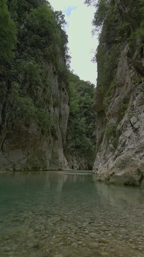 Vertical low altitude drone flight over the crystal clear Acheron river Stock-Footage 347441323