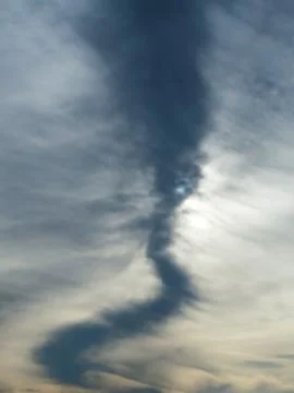 Vertical low angle of a beautiful sky with a dark cloud pattern Stock Photos