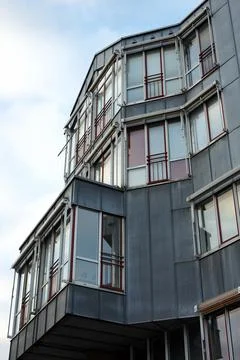 Vertical low-angle of the facade of an old apartment building with big windows Fotos de archivo