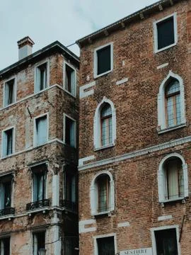 Vertical low angle shot of brick buildings building under a clear blue sky Fotos de archivo