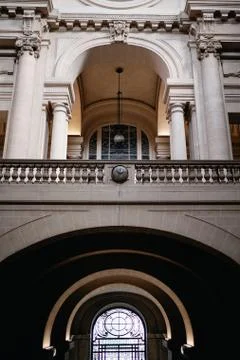A vertical low angle shot of a bridge in front of a historic building in Roub 스톡 사진