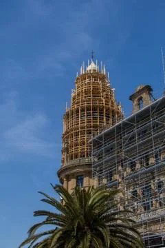 A vertical low angle shot of a building under reconstruction with the sky in  Stock Photos