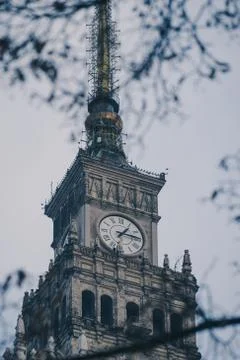 Vertical low angle shot of a clock tower with interesting patterns 스톡 사진