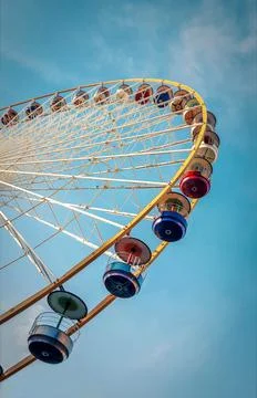 Vertical low angle shot of a Ferris wheel captured during the daytime Stock Photos
