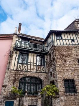 Vertical low angle shot of medieval buildings in the streets of Paris under a br Photos