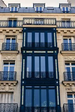 Vertical low-angle shot of a modernized medieval building exterior in Paris Stock Photos
