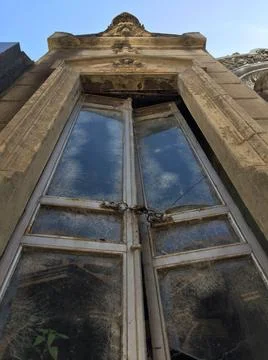 Vertical low angle shot of the old door of an abandoned building Fotos de archivo