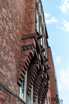 Vertical low angle shot of a red building under the beautiful cloudy sky 写真素材