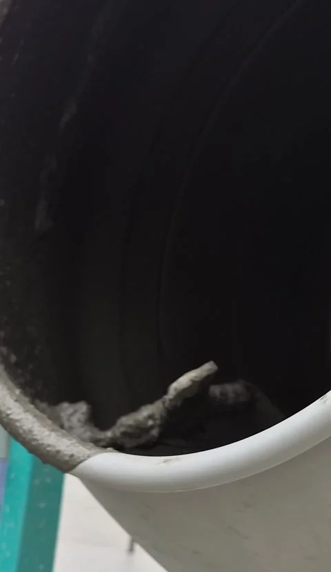 Vertical Low Angle Shot of Rotating Concrete Mixer Drum on Site Stock-Footage 332506436