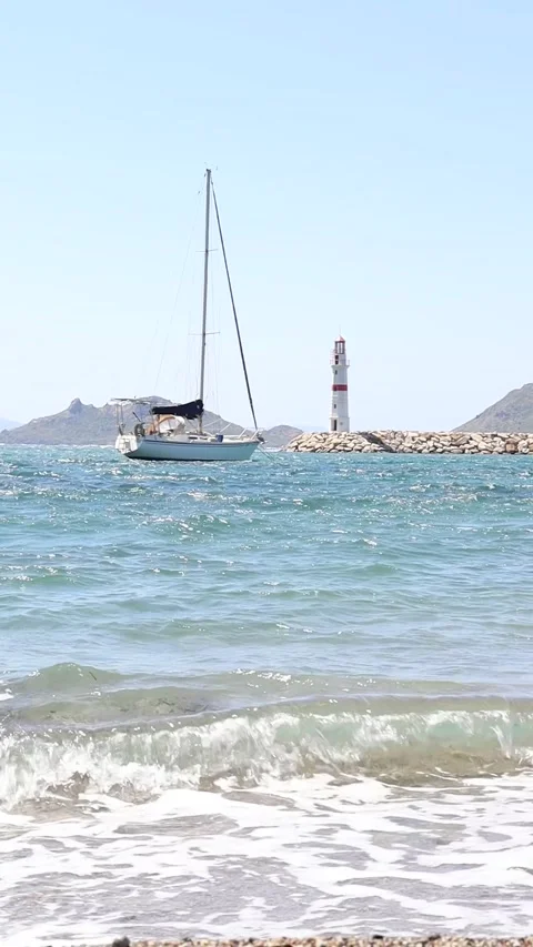 Vertical Low Angle shot of Sailboat and Lighthouse (Slowmotion 50 fps to 25 fps) Stock Footage 236661231