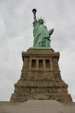 A vertical low angle shot of The Statue of Liberty in New York City with a cl Stock Photos