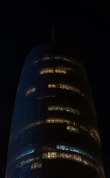 Vertical low-angle view of Burj Doha (Doha Tower) illuminated at night, Qatar Stock-Fotos