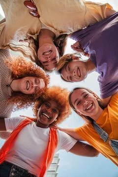 Vertical low angle view of five teenage girls laughing and looking at camera Stock Photos