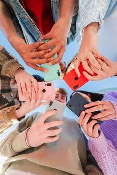Vertical low angle view of a group of unrecognizable multiracial young friends Stock Photos
