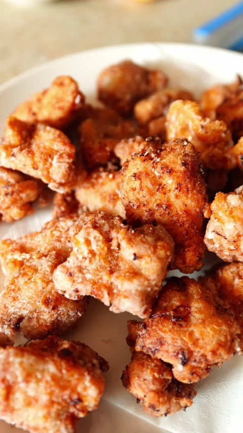 Vertical low-angle view of karaage on a white plate Stock Footage 334680373