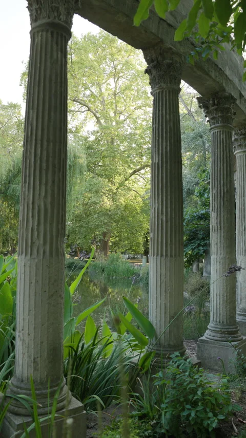 Vertical Low Angle View Looking Through Corinthian Columns Towards Park Trees an Stock Footage 340477162