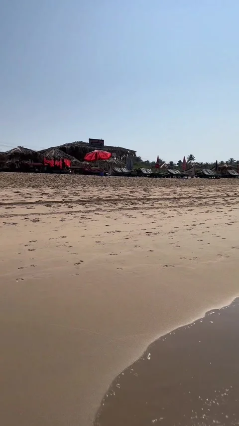 Vertical low angle view of ocean waves and beach shacks at Calangute Beach Goa 스톡 동영상 342968468