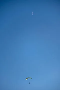 Vertical low-angle view of a person paragliding Stock-Fotos