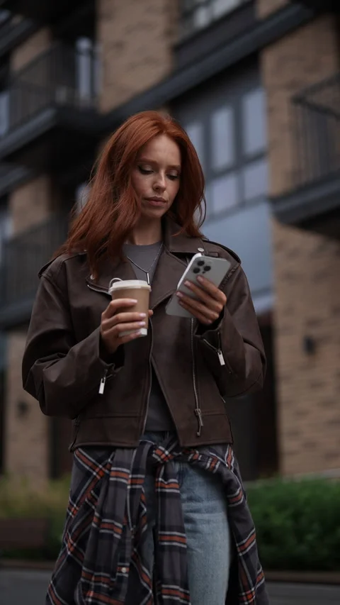 Vertical low-angle view of redhead young woman with thoughtful expression Stock Footage 282742995