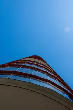 Vertical low angle view of a rounded corporate building facade Fotos de archivo