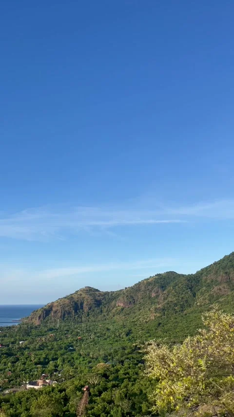Vertical Lush Green Mountains and Blue Sky Pemuteran Bali Stock Footage 335941145